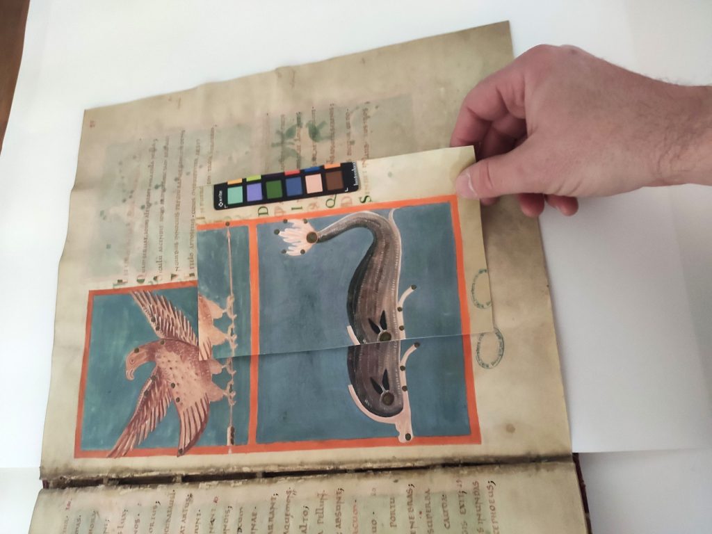 It showns a facsimile miniature being compared to the original image.